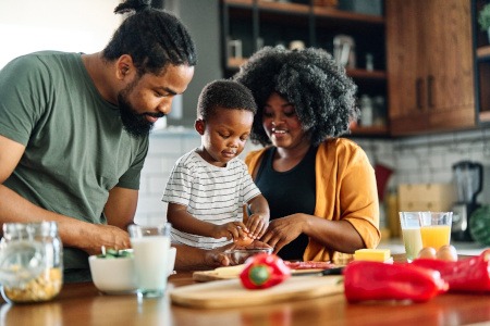 Parents making healthy meal with child