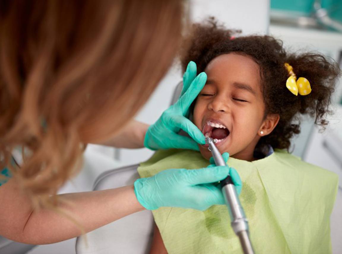 Sedated child receives dental treatment